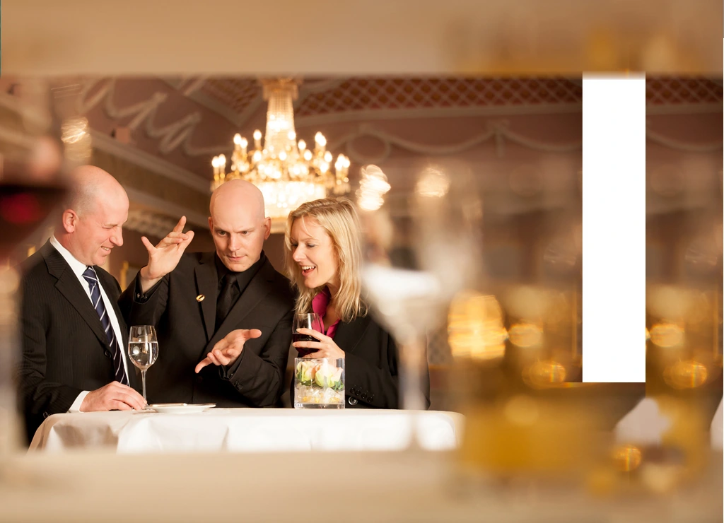 Florian Severin performing close-up magic at a festively set table in front of guests