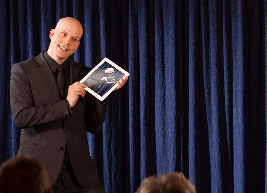 Florian Severin presenting a tablet on stage
